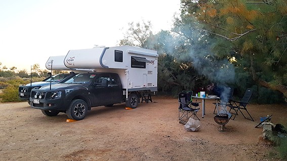 Ozcape Slide-On Motorhome, two Ozcape rigs and smoking campfire