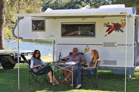 Ozcape Campers Slide-On camp with family around the table