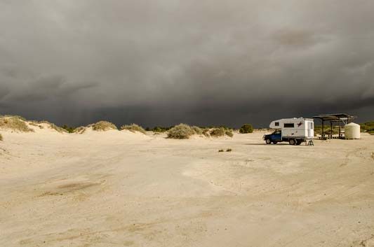 Ozcape Campers Slide-On in the desert with storms coming