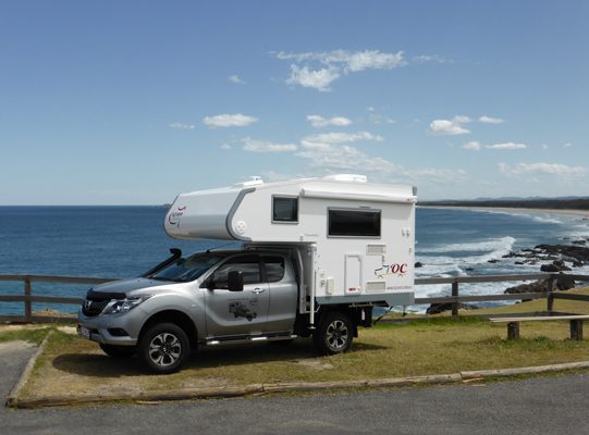 Ozcape Slide-On motorhome Woondabaa in bay with stunning ocean view