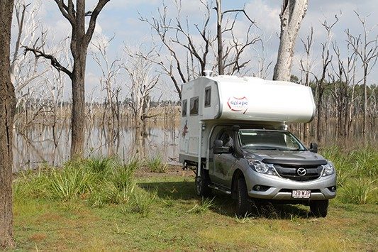 Ozcape Slide-On motorhome Woondabaa surrounded by dead woods in the water