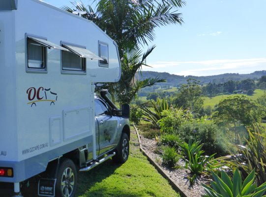 Ozcape Slide-On motorhome Woondabaa on elevated spot in the lush green hinterland