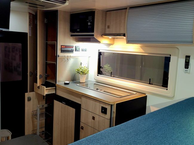 open cupboards and wardrobe in Ozcape Woondabaa truck camper