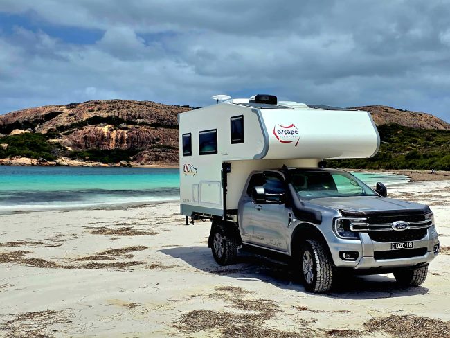 Ozcape Slide On motorhome on beach with turquoise water