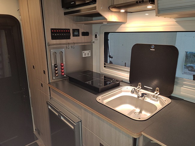 Ozcape kitchen with fridge, microwave, rangehood and large sink